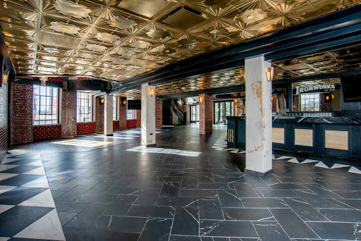 Large ballroom with brick walls and tiled floors.