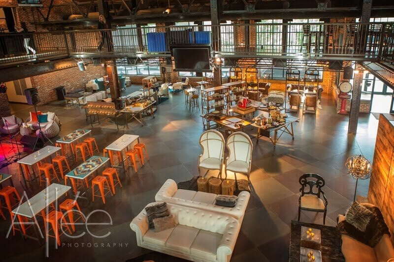 Flexible corporate event space with couches, tables, and chairs.